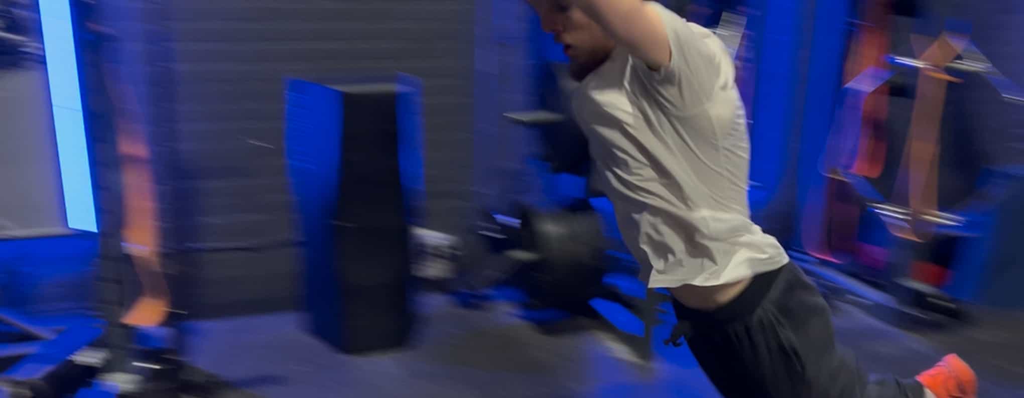 Jordan Johnson at the start of a bound, or broad jump in a gym.